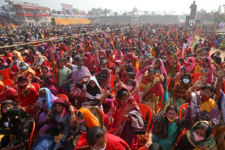 People wave as they attend a rally addressed by India nPrime Minister Narendra Modi