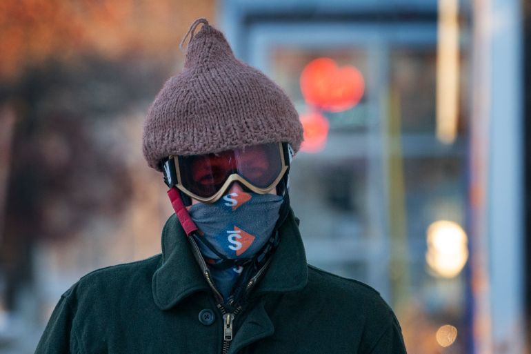 Thomas Nosal wears a hat over his helmet following his daily bicycle commute
