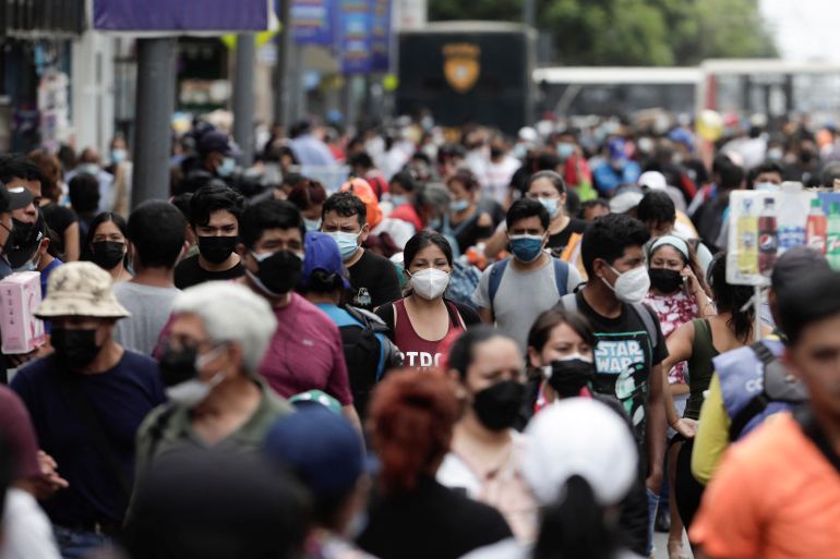 People walk in a crowded street as new cases of the coronavirus disease (COVID-19), driven by the Omicron variant, are surging, in Lima, Peru