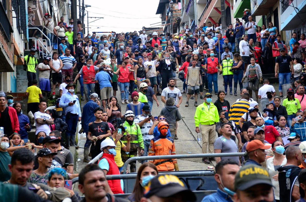 Evacuated residents watch the rescue operation