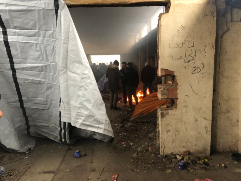 Asylum seekers trying to stay warm in an abandoned building in Serbia