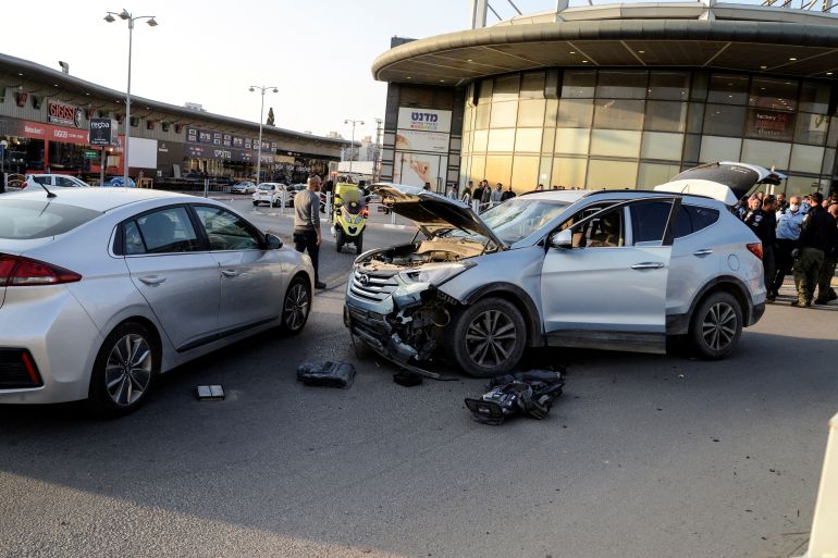 The wreckage of a car is seen at the scene of the attack in a shopping area in Beer al-Sabe [Reuters]