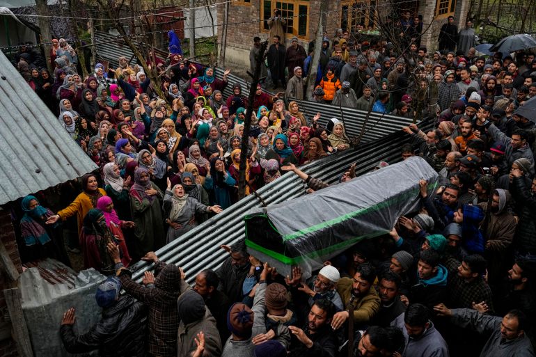 Family members and relatives mourn as they carry the body of Rafia Nazir, a young Kashmiri woman killed in grenade attack