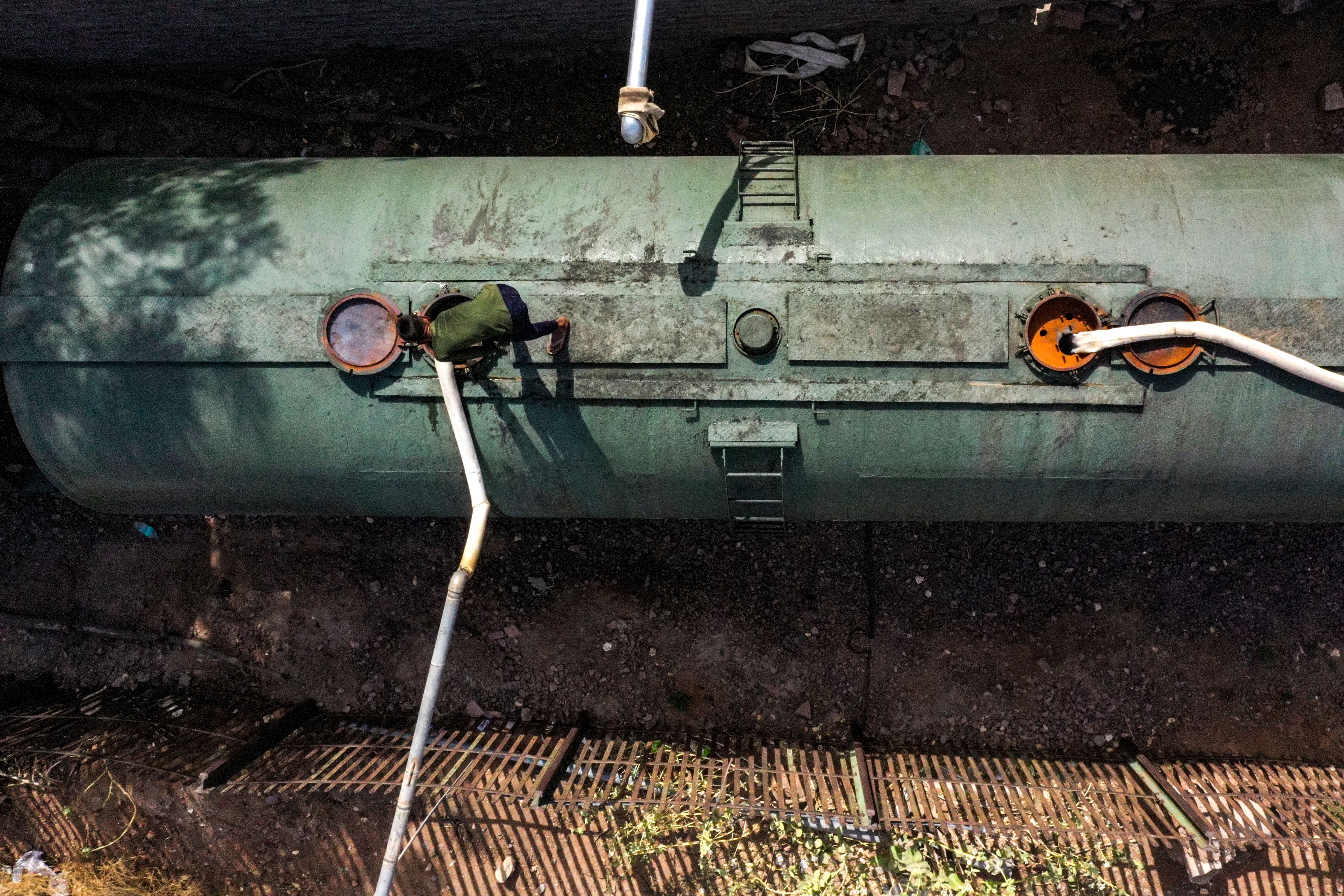 This aerial photograph taken on May 11, 2022 shows a railway employee preparing to refill the water in a tanker of a special train before dispatching for the Pali district on a hot summer day at Bhagat Ki Kothi railway station in Jodhpur