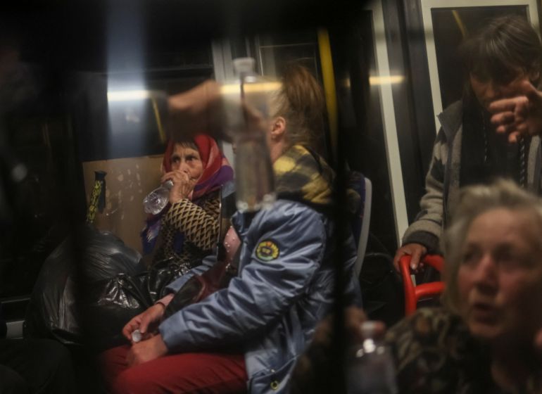 Ukrainian refugees from Azovstal are seen in a bus as they arrive at a registration and humanitarian aid centre for internally displaced people in Zaporizhzhia, May 8