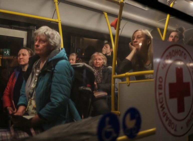 Ukrainian refugees from Azovstal are seen in a bus as they arrive at a registration and humanitarian aid centre in Zaporizhzhia, May 8