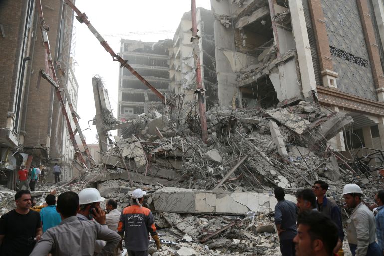 Rescue crews work at the site of a 10-storey building collapse in Abadan, Iran
