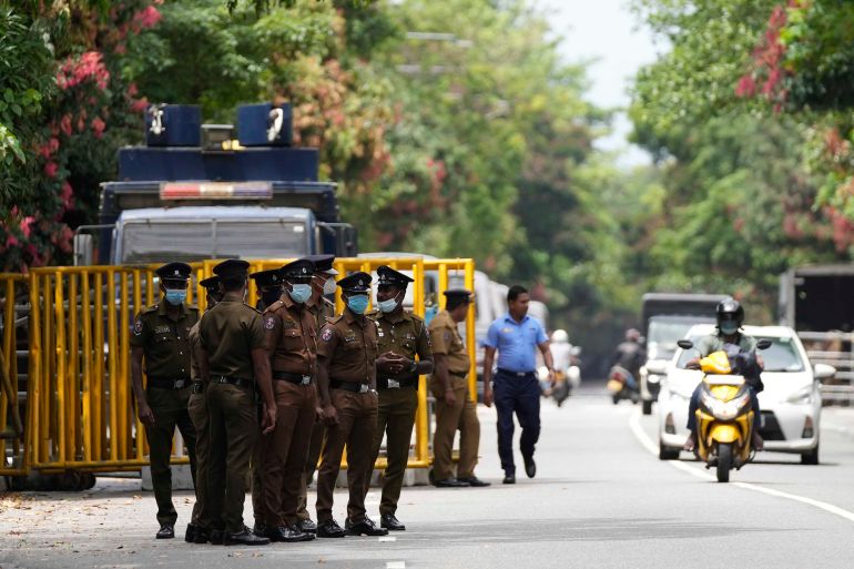 Police officers guard the entrance to the Sri Lankan parliament in Colombo