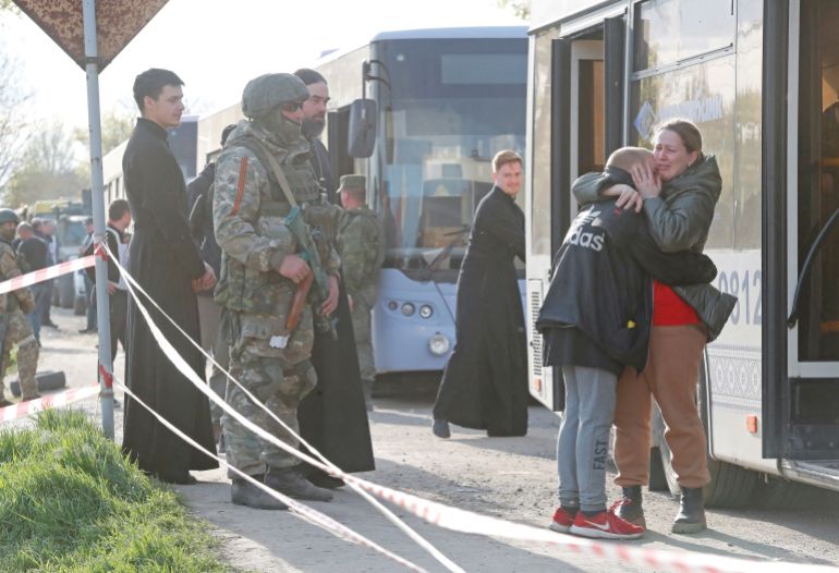 Azovstal steel plant employee Valeria, last name withheld, evacuated from Mariupol, hugs her son Matvey, who had earlier left the city with his relatives, as they meet at a temporary accommodation centre in the village of Bezimenne in the Donetsk Region, Ukraine, May 1, 2022
