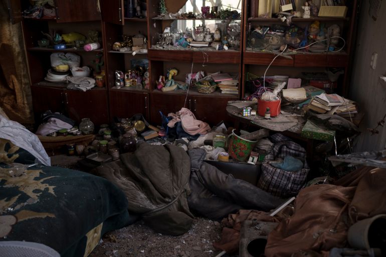 The body of a civilian lies in an apartment as Russian bombardments continue in a village recently retaken by Ukrainian forces near Kharkiv, April 30, 2022