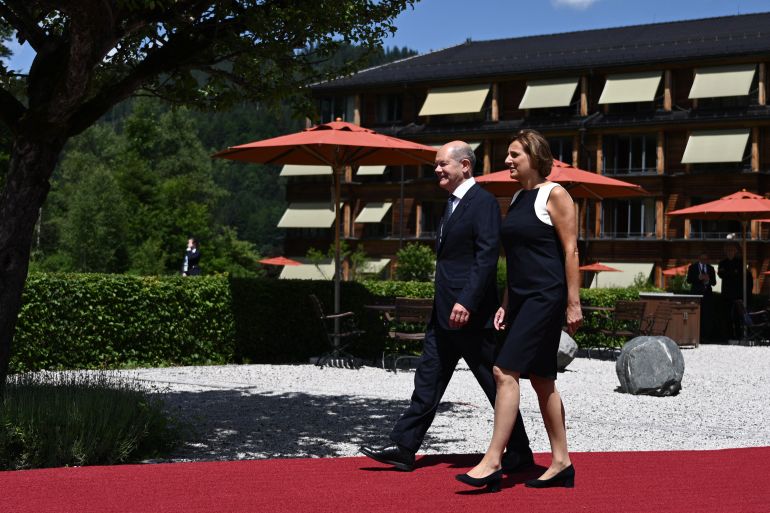 Germany’s Chancellor Olaf Scholz and his wife Britta Ernst arrive to welcome participants for the start of the G7 Summit at Elmau Castle, southern Germany, on June 26, 2022