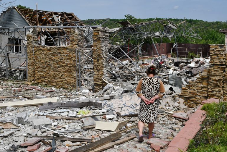An elderly woman walks next to a building damaged by an overnight missile strike in Sloviansk, Ukraine,