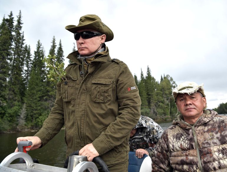 Russian President Vladimir Putin and Defence Minister Sergei Shoigu ride a boat during the hunting and fishing trip which took place on August 1-3 in the republic of Tyva in southern Siberia, Russia, in this photo released by the Kremlin on August 5, 2017
