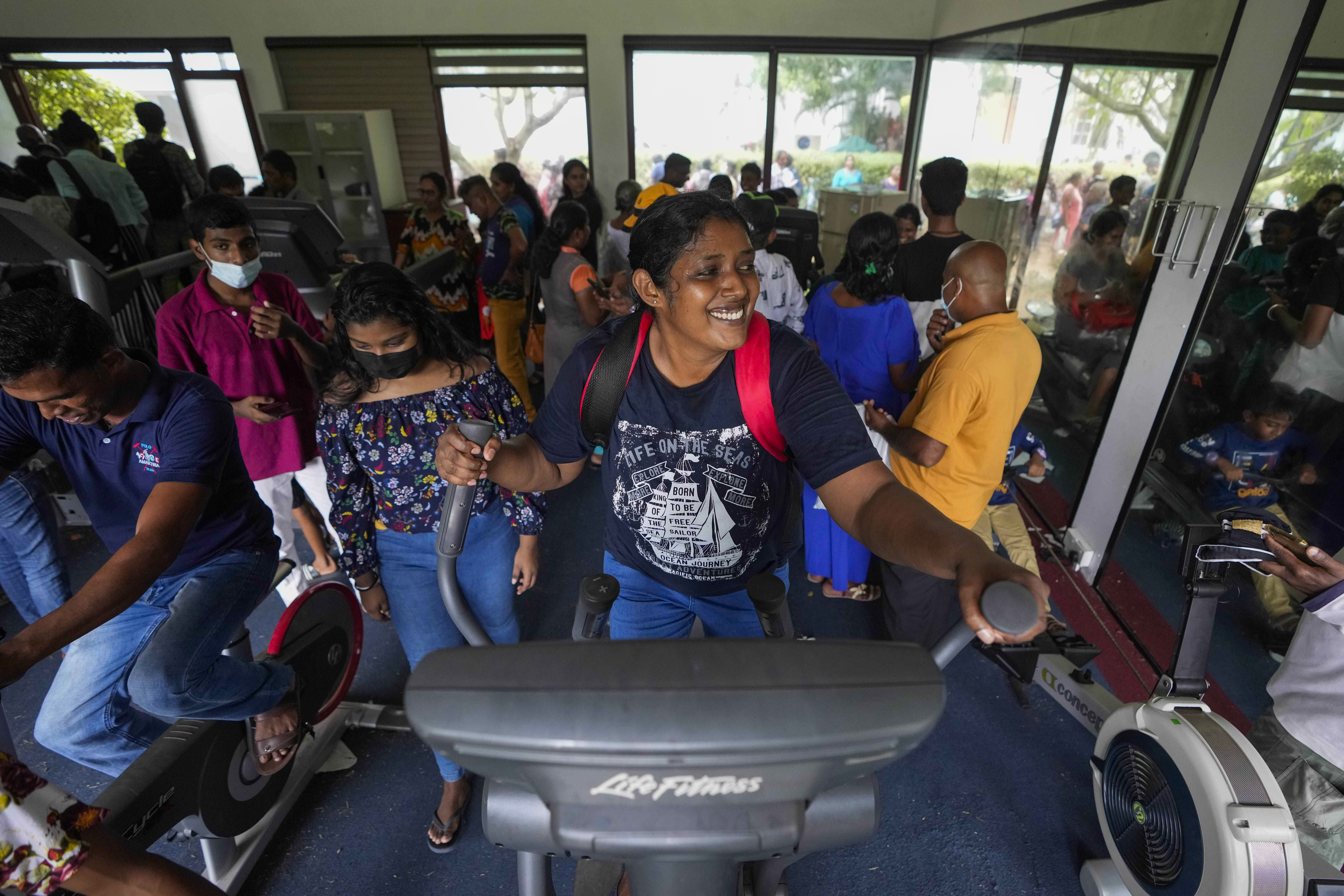 People use gym equipment as they throng President Gotabaya Rajapaksa's official residence