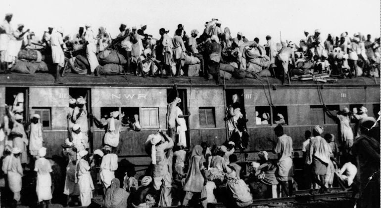 In this September 1947 photo, hundreds of Muslim refugees crowd on top of a train leaving New Delhi for Pakistan