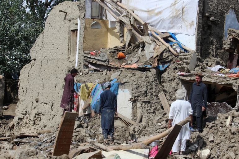 People clean up their damaged homes after heavy flooding in the Khushi district of Logar Province, Afghanistan in August 2022