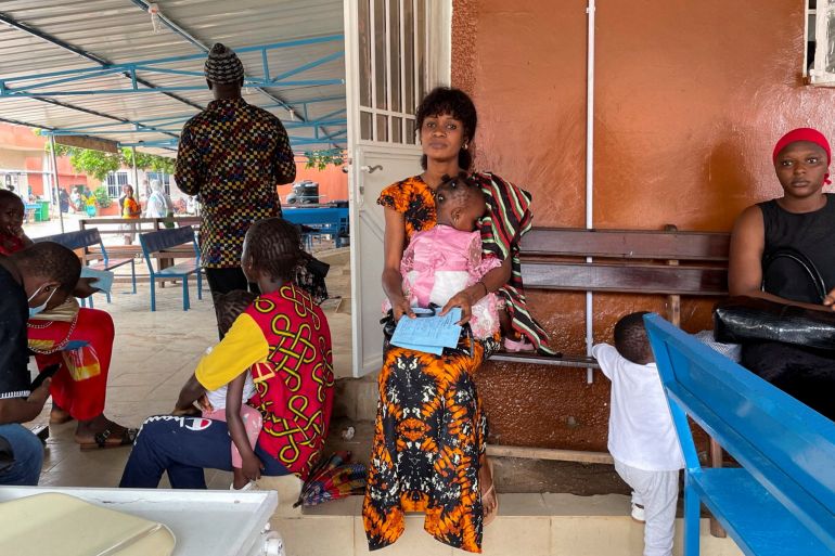 A woman waits at a hospital in The Gambia
