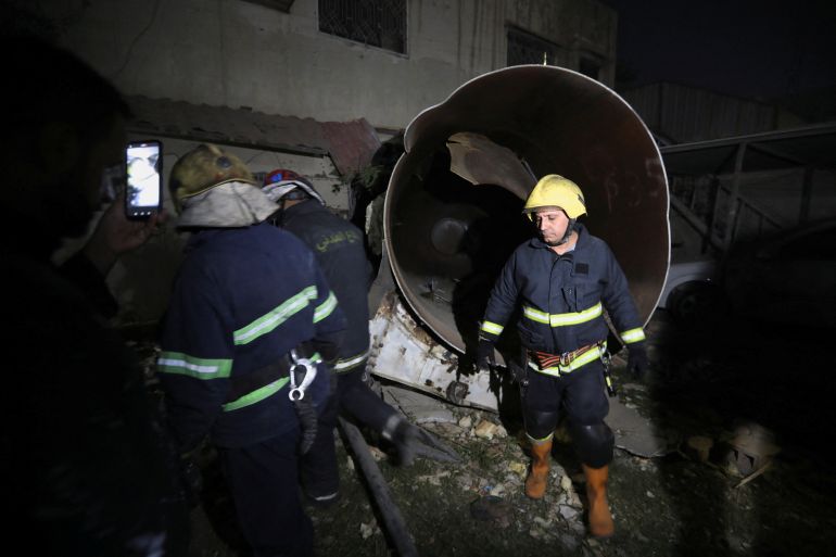 Firefighters inspect the site of an explosion in Baghdad, Iraq, October 29, 2022.