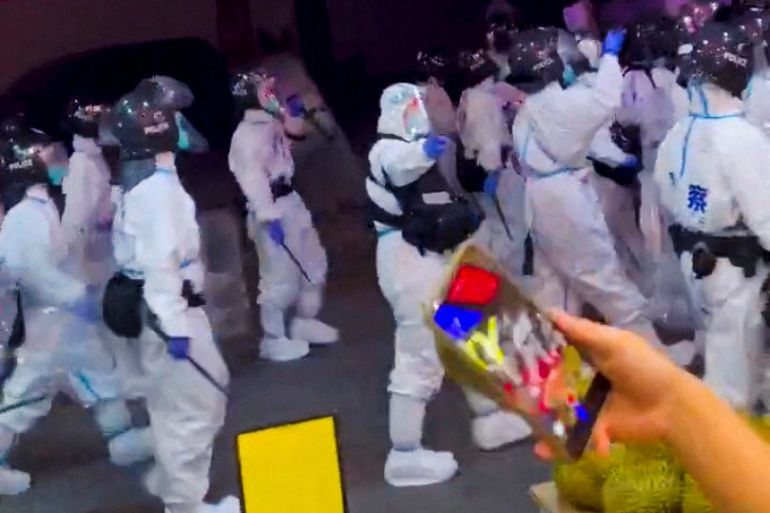 Hazmat suited riot police on the streets of Guangzhou in grainy footage taken from video