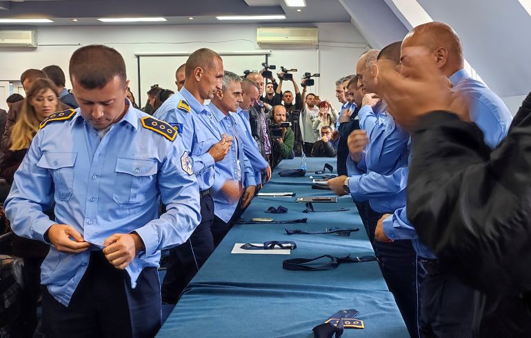 Serb police officers took off their uniforms in the town of Zvecan, Kosovo.