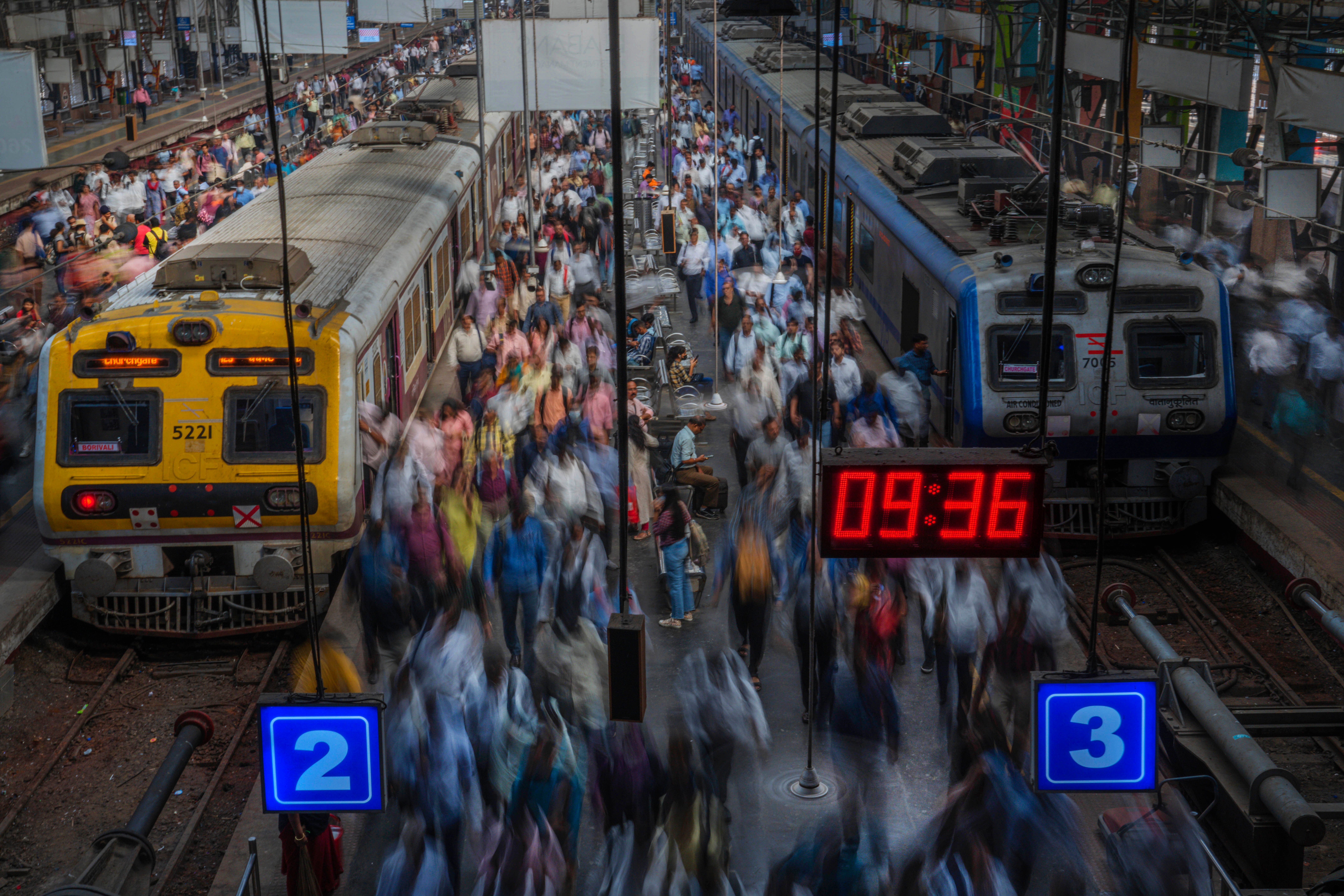 Indian commuters get off trains at the Church Gate railway station.