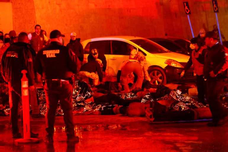SENSITIVE MATERIAL. THIS IMAGE MAY OFFEND OR DISTURB Mexican authorities and firefighters remove injured migrants, mostly Venezuelans, from inside the National Migration Institute (INM) building during a fire, in Ciudad Juarez, Mexico March 27, 2023