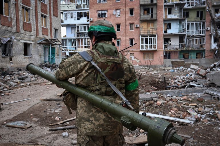 Ukrainian soldier carries a portable anti-aircraft missile system in the area of the heaviest battles with the Russian invaders in Bakhmut, Donetsk region, Ukraine, Wednesday, March 15, 2023. (AP Photo/Roman Chop)