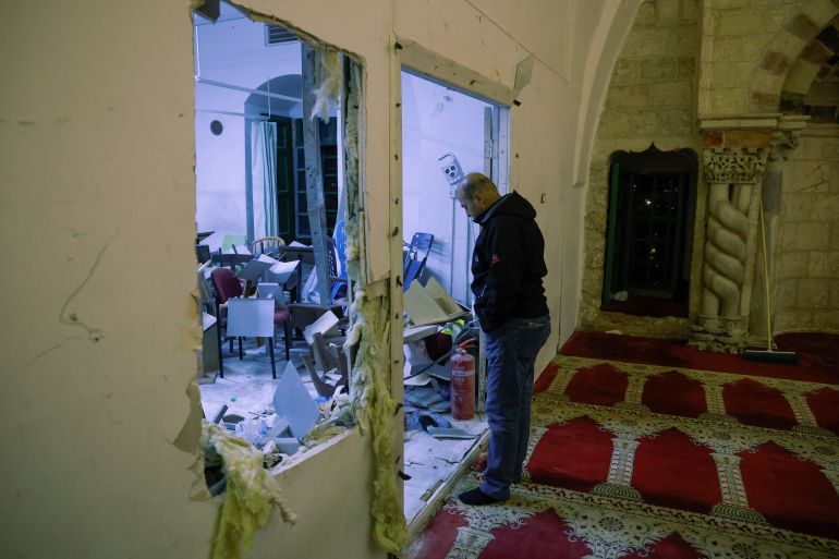 A man looks at the damage in the Al-Aqsa Mosque, on April 5, 2023