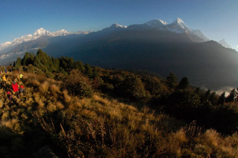 Trekkers watch the sun rise over the Annapurna Range in central Nepal