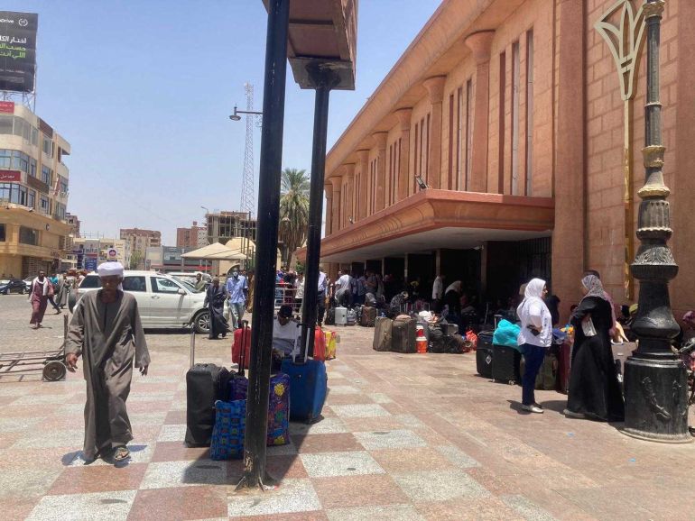 Sudanese people gathering outside Aswan train station to try to head to Cairo, on Friday [Al Jazeera]