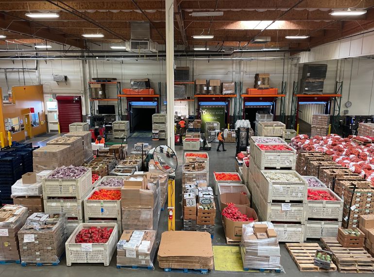 A warehouse in California filled with boxes of food for distribution to families in need [California Association of Food Banks]