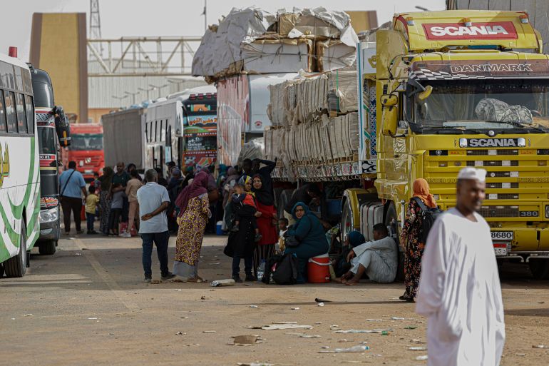 Passengers fleeing war-torn Sudan are pictured before crossing into Egypt through the Argeen Land Port on May 12, 2023. (Photo by Khaled DESOUKI / AFP)