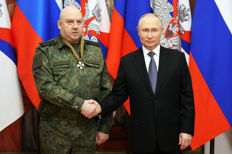 Russian President Vladimir Putin, right, awards General Sergei Surovikin with the Order of St George, third class, in December 2022