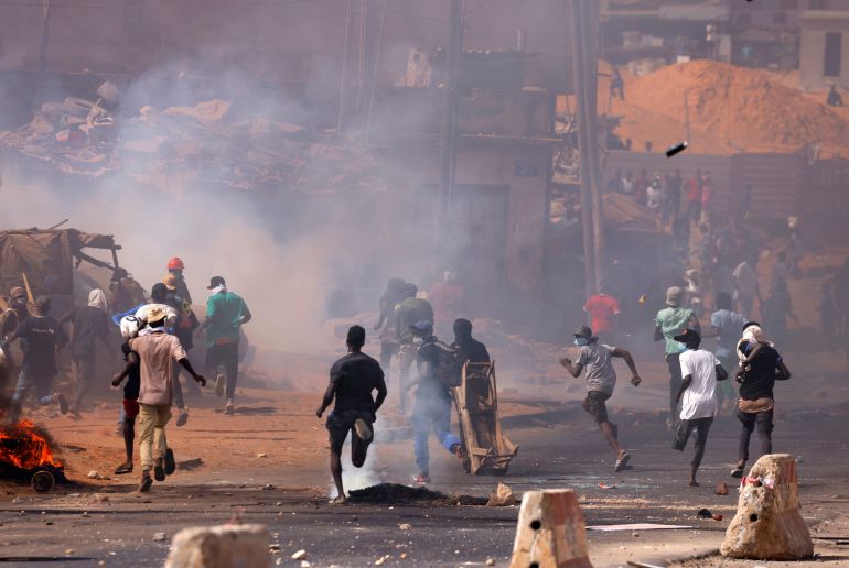 Supporters of Senegal opposition leader Ousmane Sonko run away as they clash with security forces, after Sonko was sentenced to prison in Dakar, Senegal on June 2, 2023