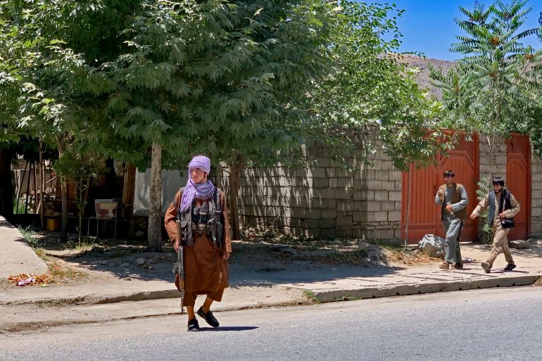 A Taliban security officer stands guard after a bomb explosion during funeral prayers at the Nabawi Mosque in the Hesa-e-Awal area of Faizabad district, in Badakhshan province