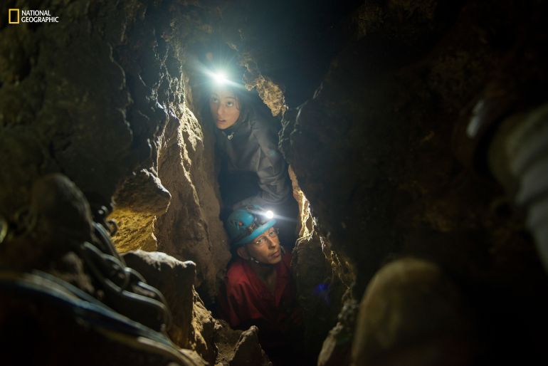 National Geographic’s explorer-in-residence Lee Berger’s daughter, Megan, and underground exploration team member Rick Hunter navigate the narrow chutes leading to the Dinaledi Chamber of the Rising Star Cave in South Africa