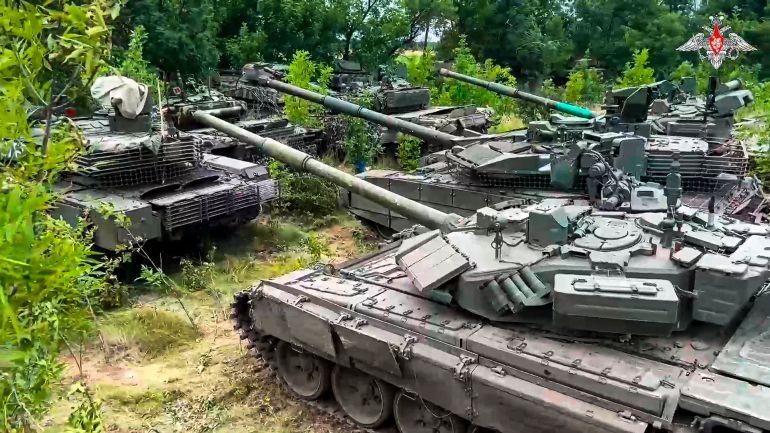 Wagner tanks parked amid greenery.
