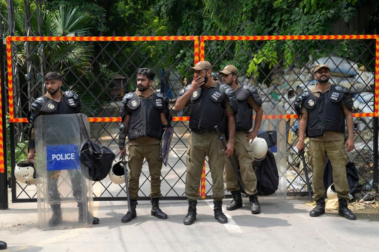 Police officers stand guard outside the residence of Pakistan’s former Prime Minister Imran Khan in Lahore, Pakistan, on Saturday
