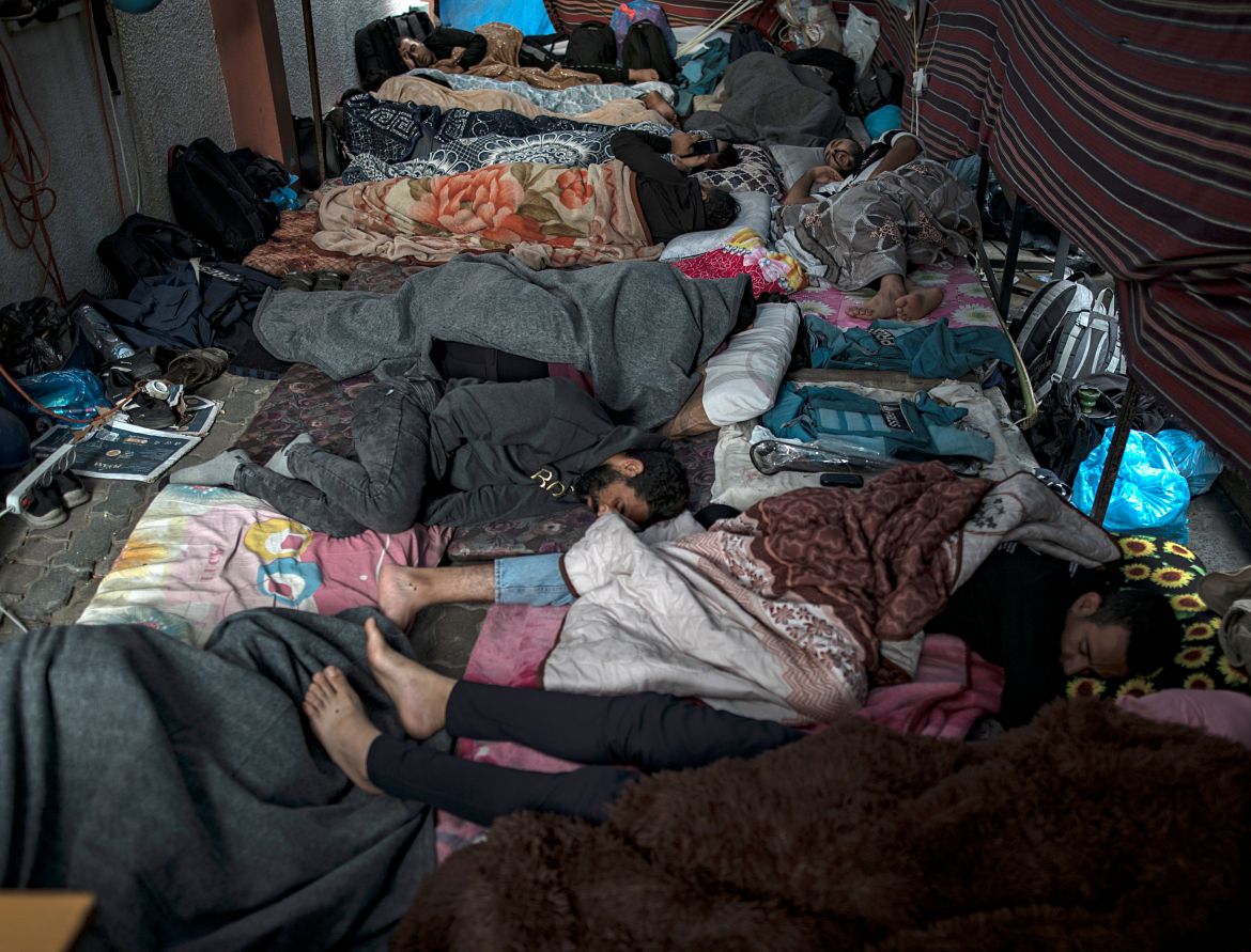 Displaced Palestinians sleep on the hospital floor at Nasser Hospital, in Khan Yunis, southern Gaza Strip.