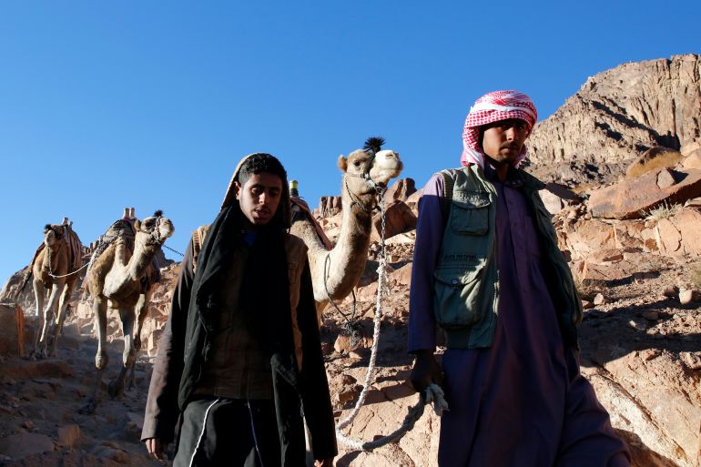 Bedouin mountain guides make their way down from the summit of Mount Moses, near the city of Saint Catherine, in the Sinai Peninsula, south of Egypt, December 9, 2015. According to the Bible, the mountain is where Moses received the ten commandments from God. Picture taken December 9, 2015. REUTERS/Amr Abdallah Dalsh