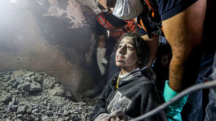 A woman and 13-year-old a girl, May Saad are rescued alive under the rubble of the destroyed building belonging to Al Astal family by civil defense teams and local people as Israeli attacks continue on the 32nd day, in Khan Yunis