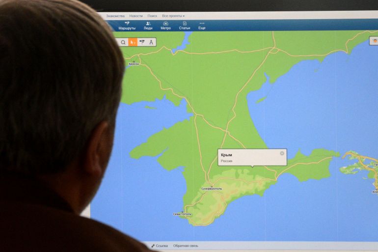 A man looks at a computer screen in Moscow on March 21, 2014, displaying a map of the Crimean Peninsula with a pop-up window reading: ‘Crimea, Russia’ on the site of Russian internet company Mail.Ru [AFP]