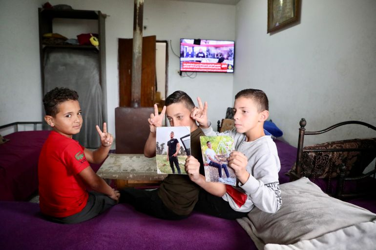 Ubai’s brothers and cousin in the neat-as-a-pin family room