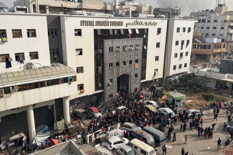 Displaced Palestinians gather in the yard of Gaza’s al-Shifa Hospital on December 10, 2023, as battles continue between Israel and Hamas in the Palestinian territory
