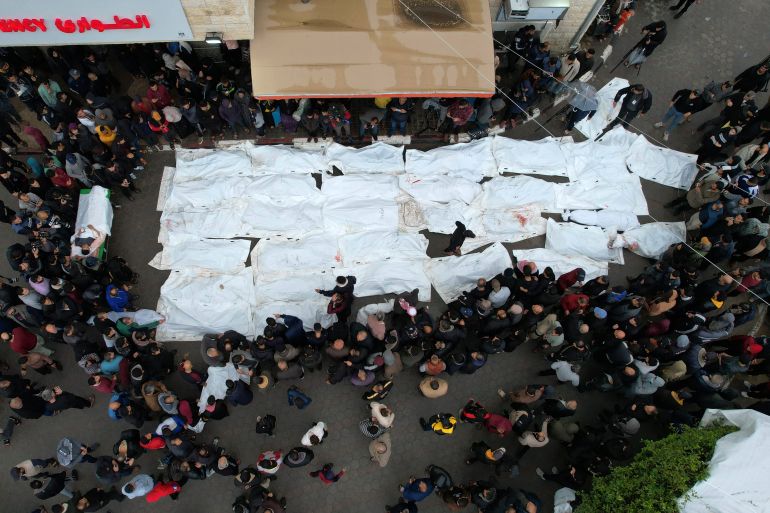 An aerial view shows Palestinians mourning their relatives, killed in an overnight Israeli strike on the Al-Maghazi refugee camp, during a mass funeral at the Al-Aqsa hospital in Deir Al-Balah