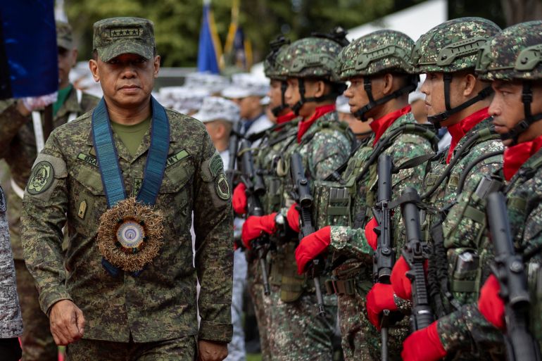 Armed Forces of the Philippines Chief of Staff General Romeo Brawner Jr walks past honour guards during the arrival ceremony at Western Command, Puerto Princesa, Palawan, Philippines, August 10, 2023