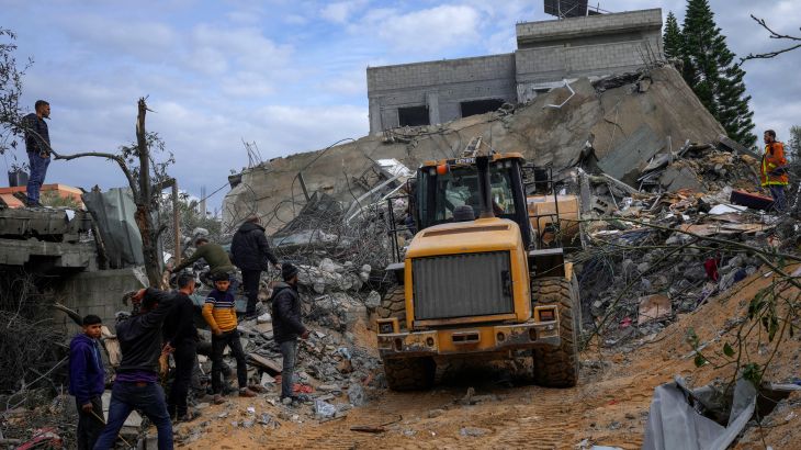 Palestinians search for survivors after an Israeli airstrike on a residential building in Al Zawayda, central Gaza Strip