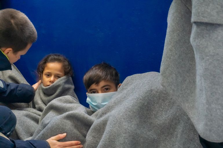 One of Rania's daughters, comforted in the cold. [Nora Adin Fares/Al Jazeera]