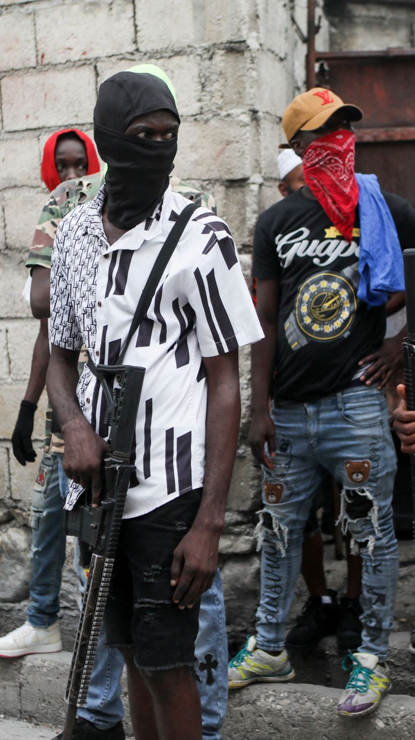 Haitian gang members provide security to Jimmy 'Barbecue' Cherizier, head of the G9 gang coalition, in Port-au-Prince