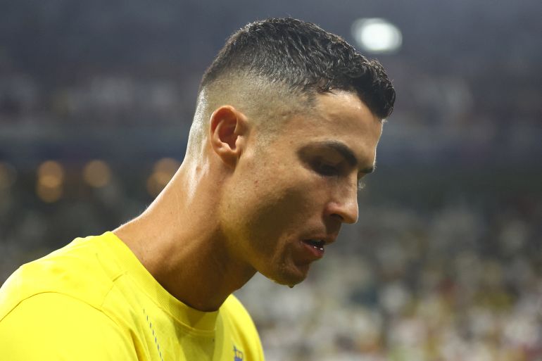 Al Nassr's Cristiano Ronaldo walks on field.